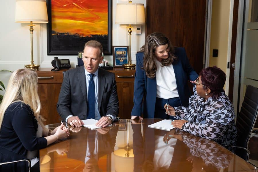 Charles Scholle and Annette Malena meeting with clients