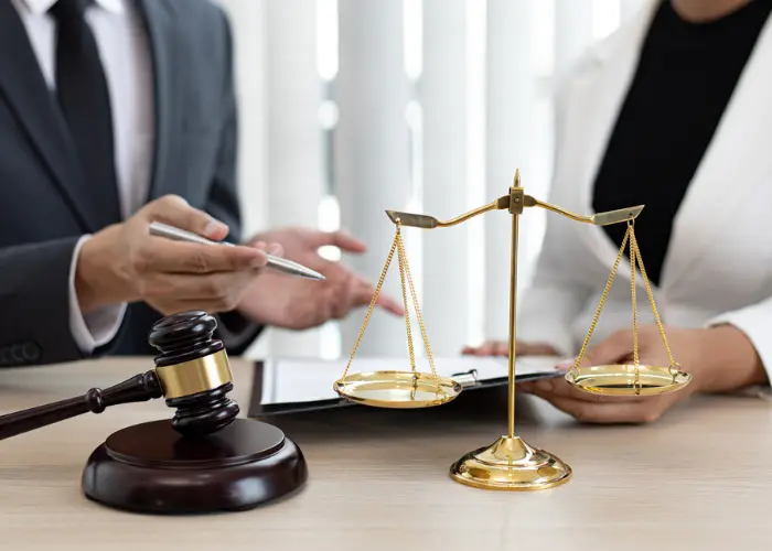 Lawyers with Judge Gavel and Justice Scales on Table