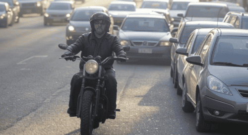 heavy traffic on city streets with oncoming cyclist